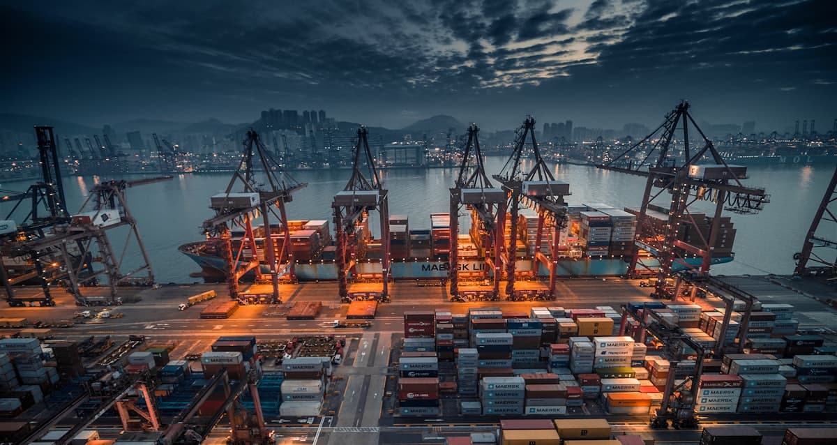 Container ship being loaded by cranes at a port