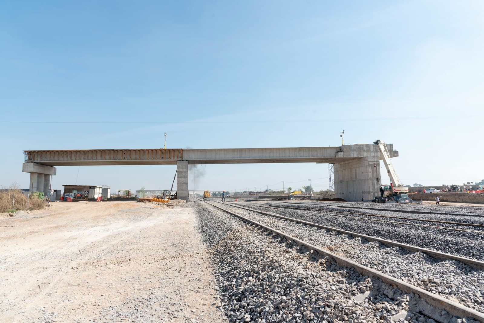 A bridge under construction above railway tracks