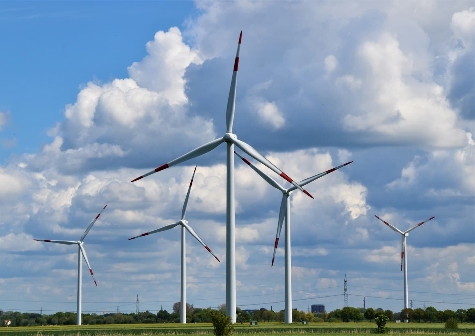 Wind turbines on open farmland under a cloudy sky