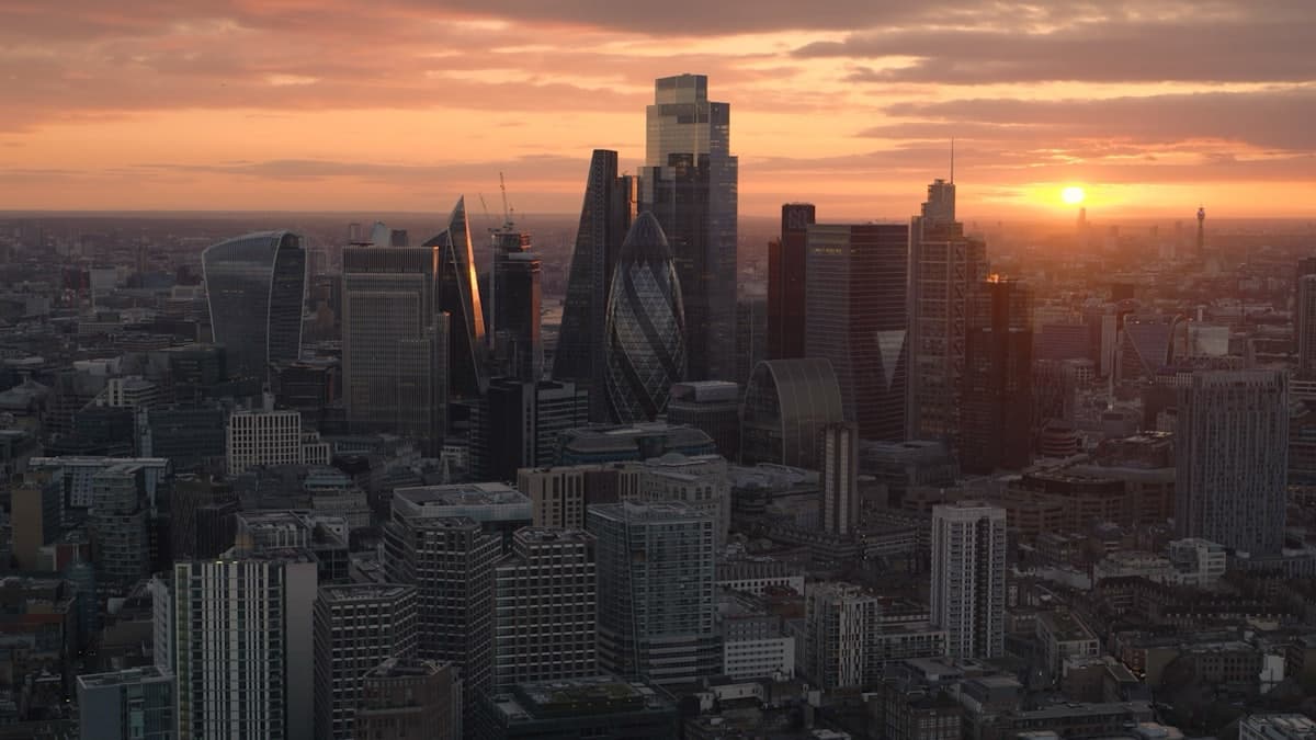 Modern financial district skyline at sunset