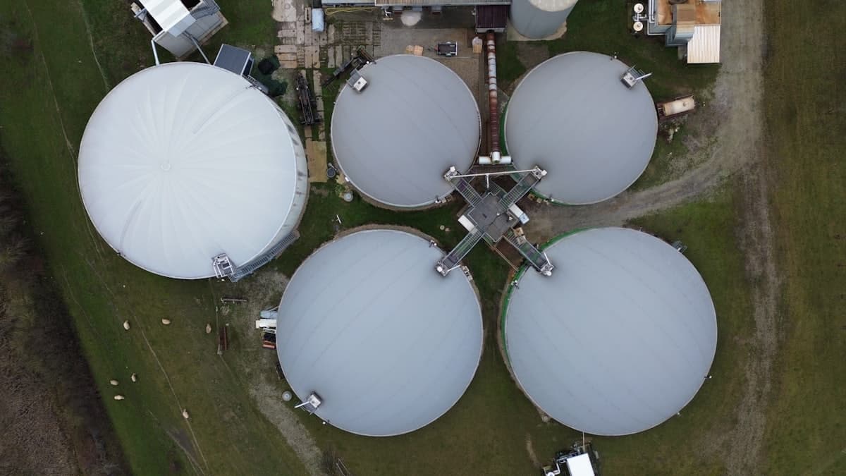 Digester tanks at a biogas facility in green fields