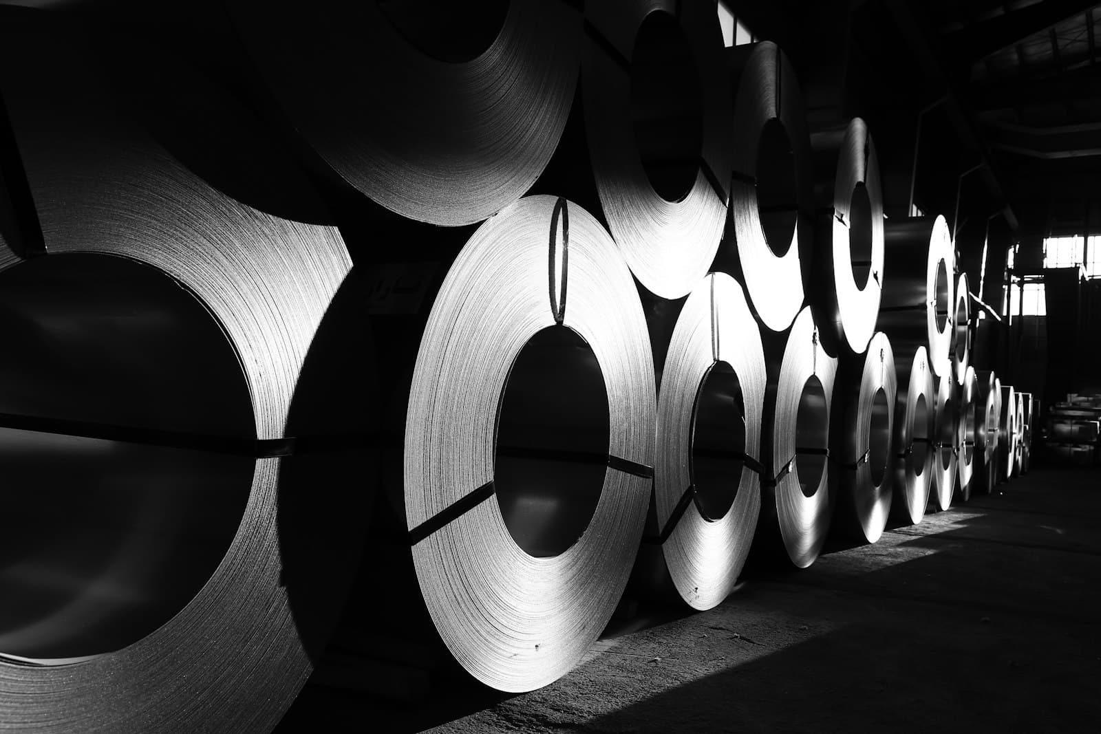 Coils of steel stacked in a metals warehouse