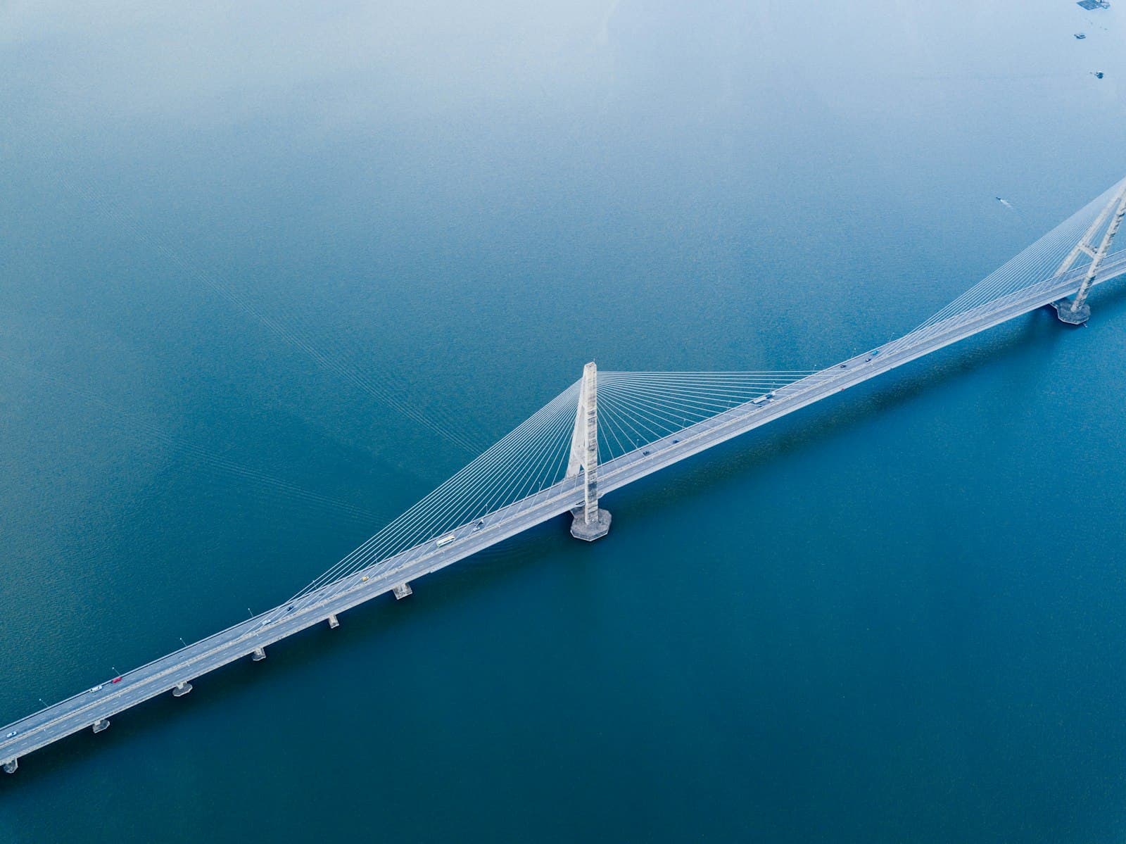 Aerial view of a cable-stayed bridge spanning open water