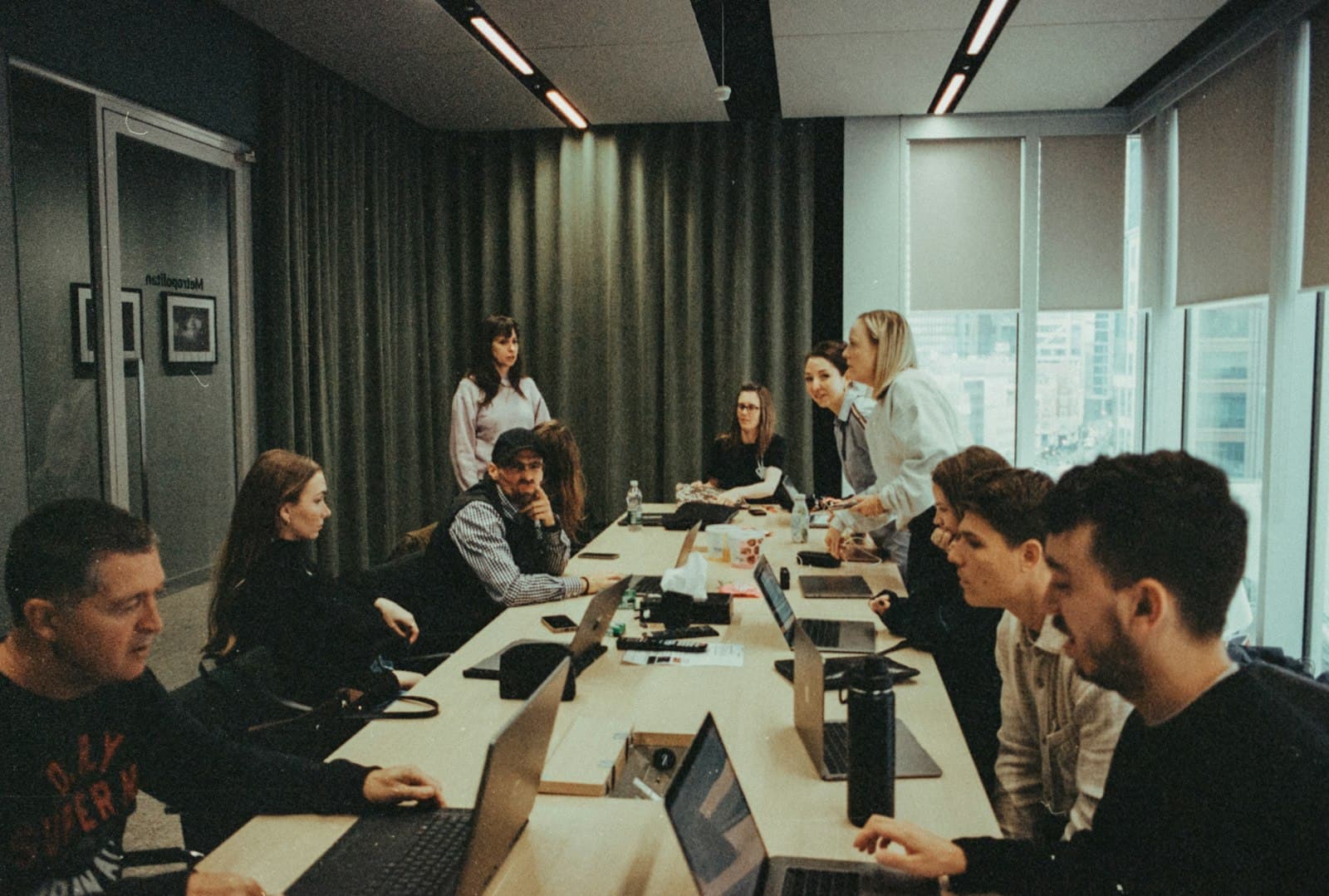 A team in discussion around a long meeting table