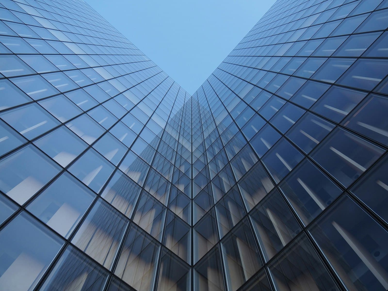 Looking up at glass office towers against the sky